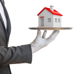 man with white glove holding model of house